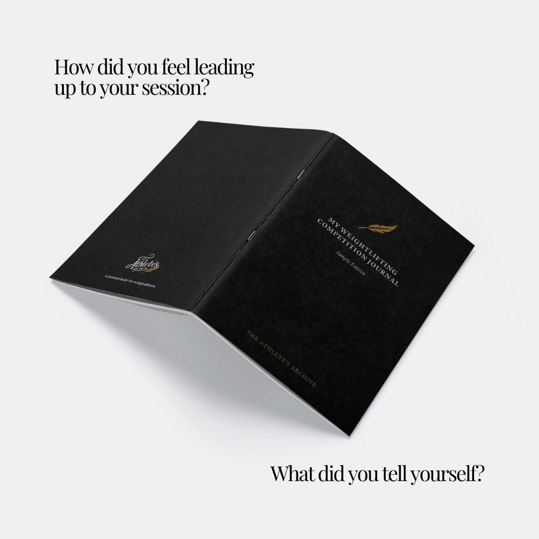 Open, faced down, black journal on a white background